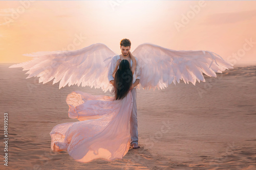 Foto Men angel hugs young woman
