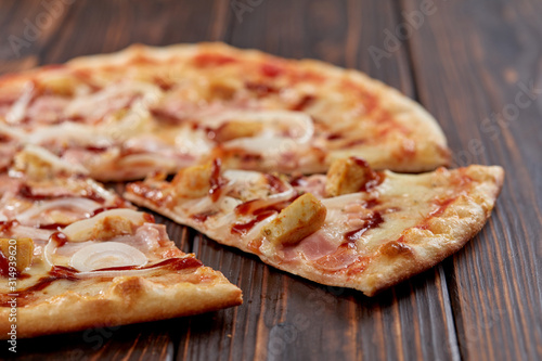 tasty pizza on the wooden background