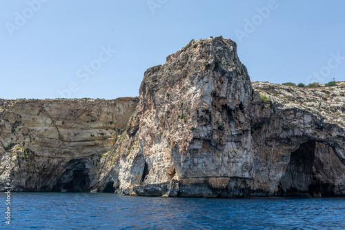 rocks in the sea. Mountain slopes on the background of the sea shore. Seascape with mountain landscape. Photo of a sea landscape.