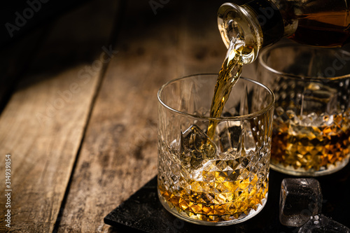 Foto Whiskey in glasses on wood background, copy space, toned