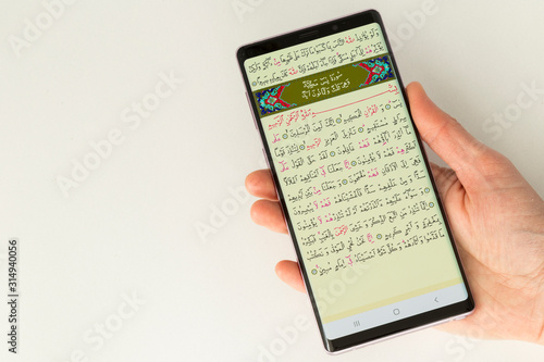 Reading Koran on the smart phone application.