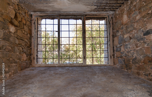 view from an old building through a window with metal bars
