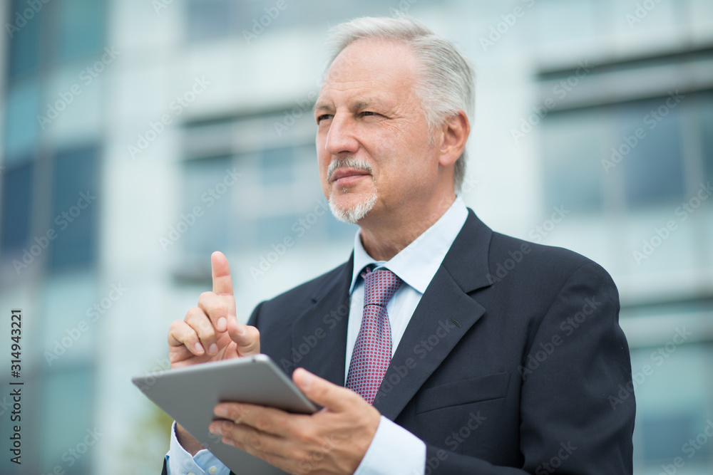 Business man using his tablet outdoor Business man using his tablet outdoor