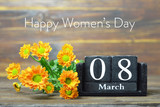 Happy Internacional Womens Day card. Wooden calendar and orange chrysanthemum flowers