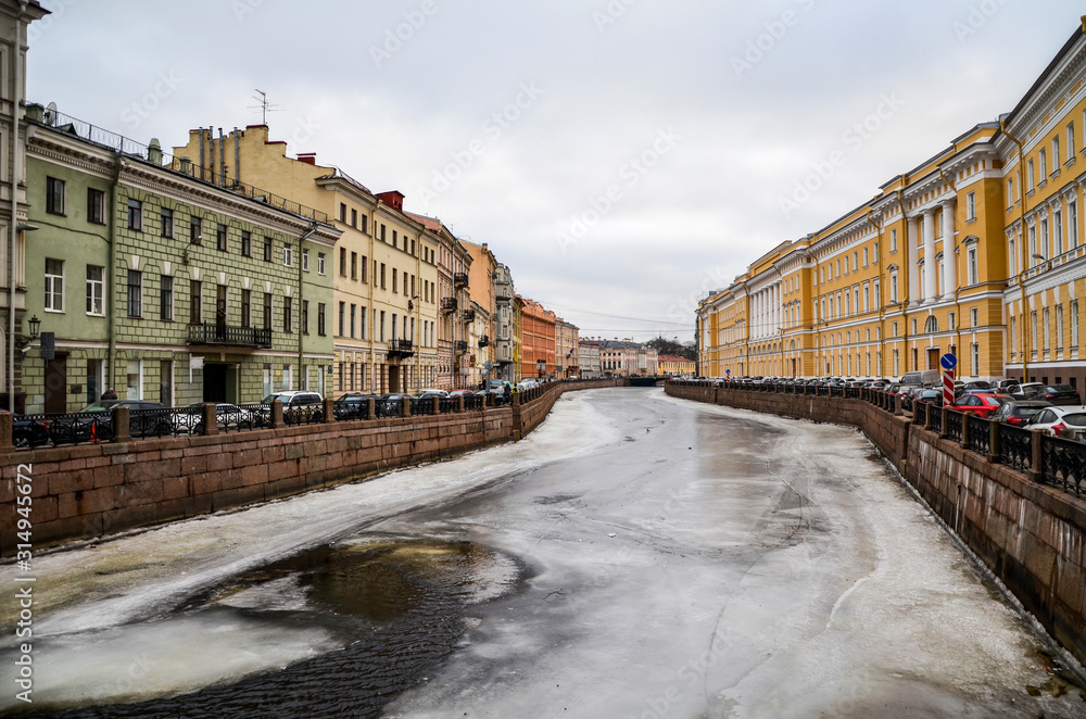 Frozen water surface on the winter canal in the center of St. Petersburg, Russia
