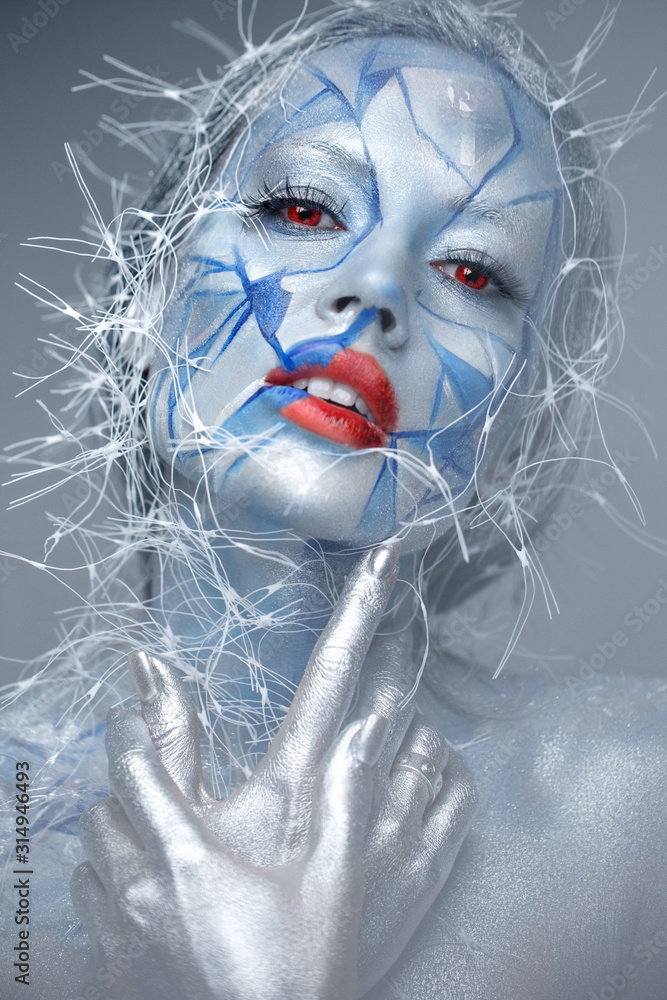 Beautiful girl in an unusual winter look with red lips. Creative make- up. Art look. - obrazy, fototapety, plakaty 