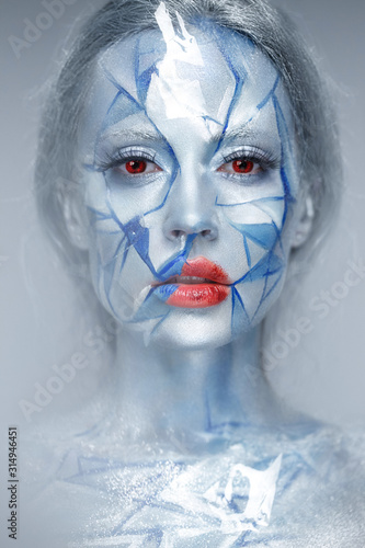 Fototapeta Naklejka Na Ścianę i Meble -  Beautiful girl in an unusual winter look with red lips. Creative make- up. Art look.