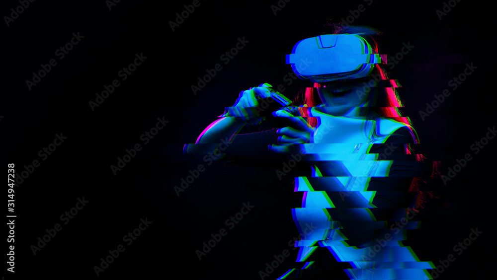 Naklejka premium Woman with virtual reality headset is playing game. Image with glitch effect.