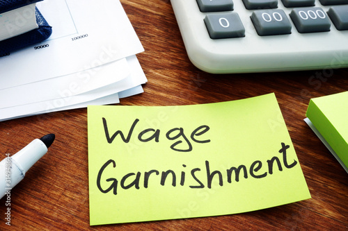 Fotografie Wage Garnishment written on the yellow sheet.