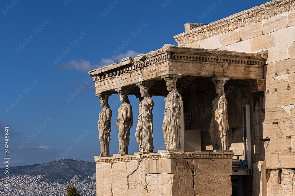 Obraz premium The Erechtheion (or Erechtheum, 406 BC) with Caryatids - ancient Greek temple on the north side of the Acropolis. Erechtheion dedicated to both Athena and Poseidon. Athens, Greece.