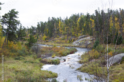 River leading to lake in Autumn forests in Canada