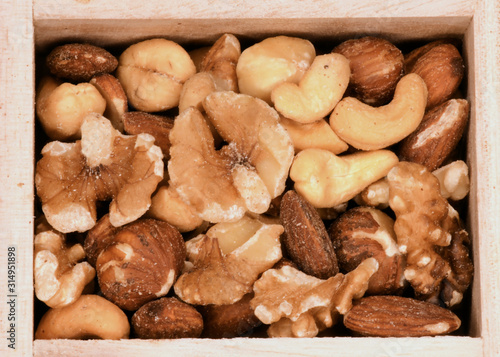 mixed salted nuts- almonds, walnuts, cashews, and hazel nuts- in a wooden box