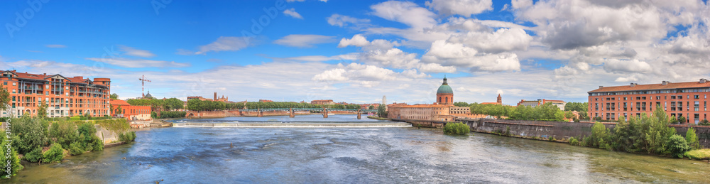 Summer city landscape, panorama, banner - view of the Garonne river in the city of Toulouse, in the historical province Languedoc, the region of Occitanie of southern France