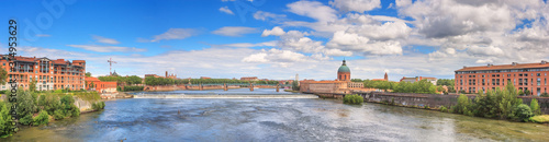 Summer city landscape, panorama, banner - view of the Garonne river in the city of Toulouse, in the historical province Languedoc, the region of Occitanie of southern France