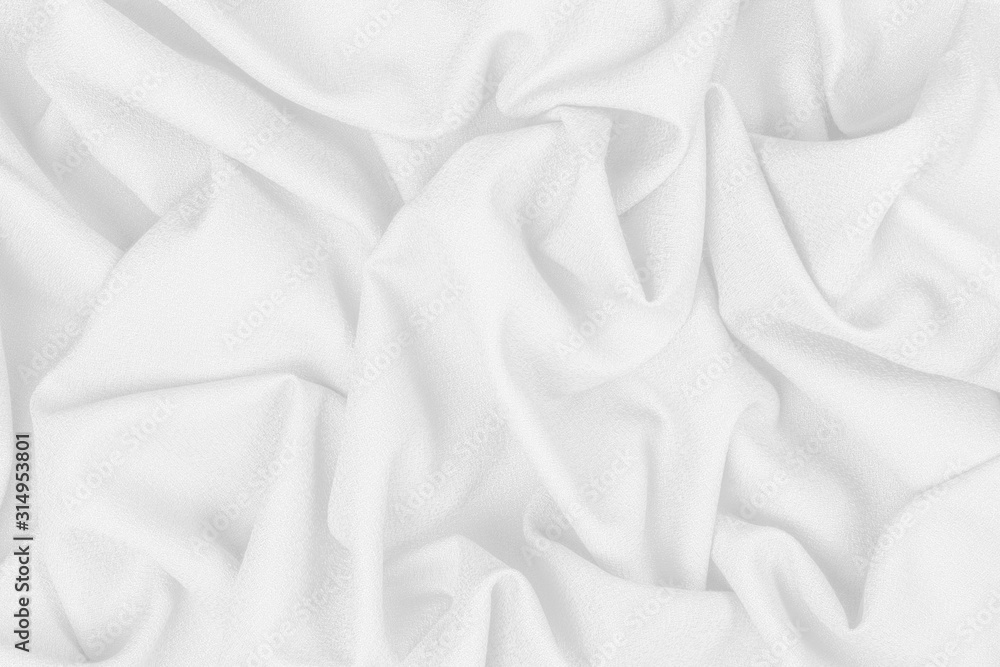White woolen crumpled fabric with wrinkles and waves, closeup, background of crumpled tissue