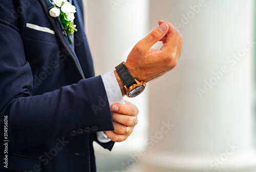 The groom in an expensive classic blue suit