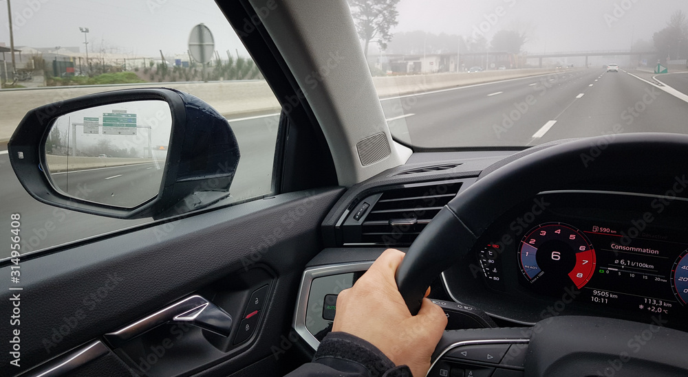 Driving car on highway in fog weather, interior driver view