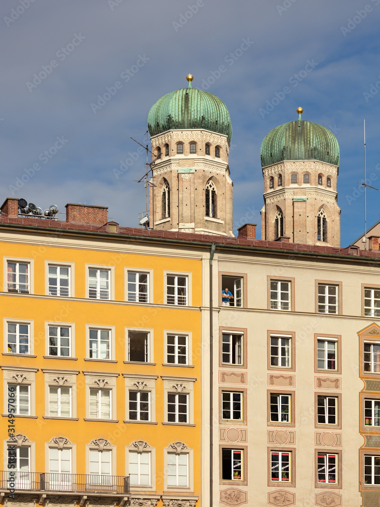 Spires of Frauenkirche behind facades of houses at Marienplatz Spires of Frauenkirche behind facades of houses at Marienplatz