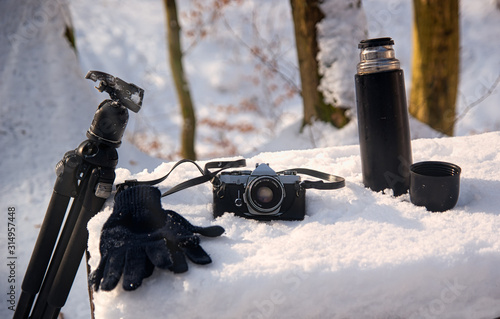 camera and hiking equipment in the snow , close view
