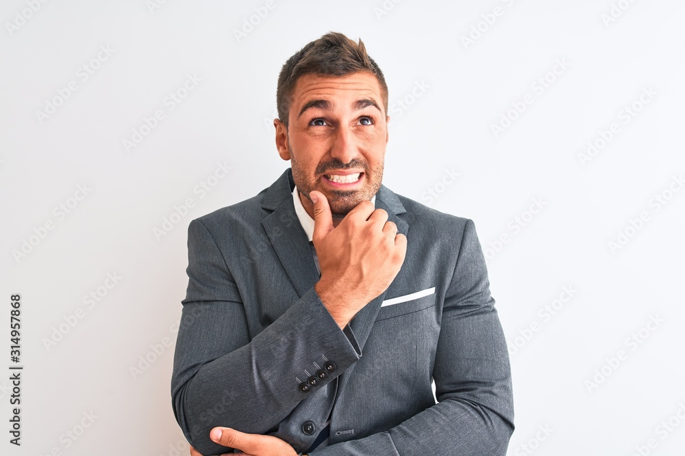 Young handsome business man wearing suit and tie over isolated background Thinking worried about a question, concerned and nervous with hand on chin Young handsome business man wearing suit and tie over isolated background Thinking worried about a question, concerned and nervous with hand on chin