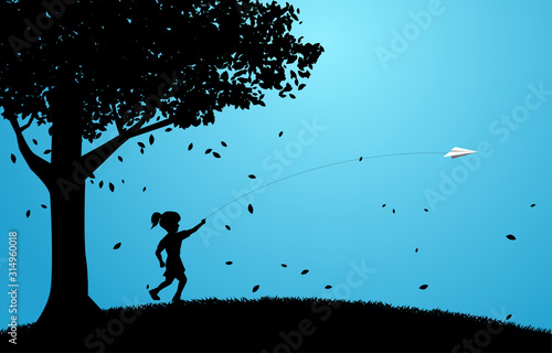 silhouette of girl running to throw out origami paper airplane under big tree. Concept of children play and learn.