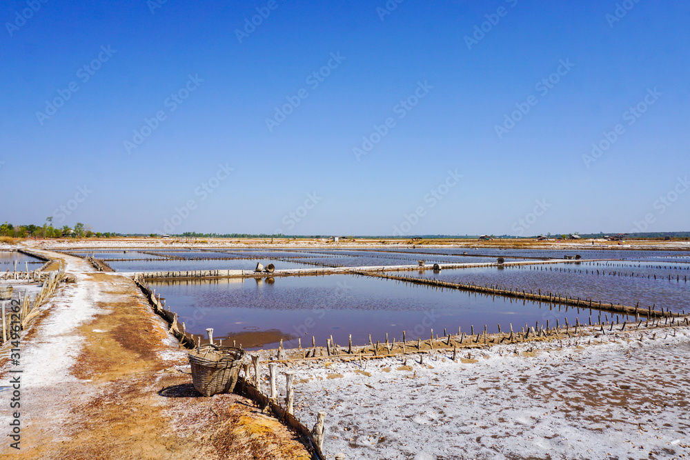 production of industrial salt in the oldest salt mines on a sunny day - salt farm