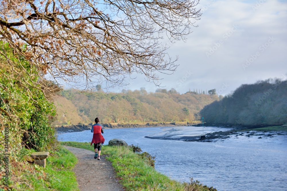 Jogger along the river at Lannion in Brittany. France Jogger along the river at Lannion in Brittany. France