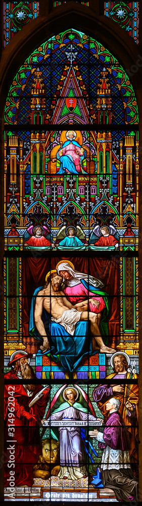 Bratislava, Slovakia. 2019/11/4. Stained glass window depicting the Pieta – the Grieving Virgin Mary holding her dead Son Jesus Christ in her arms. St Martin's Cathedral, Bratislava, Slovakia.