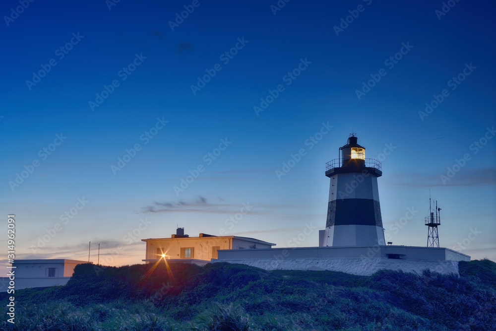 Fuguei Cape Lighthouse at sunset at the coast of Shimen, Taiwan