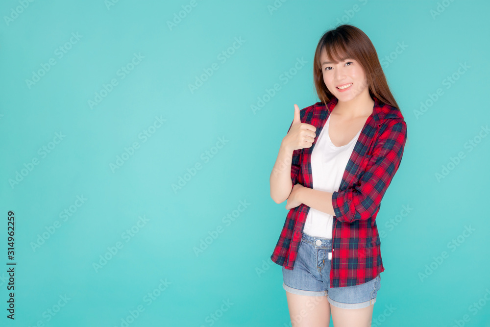Beautiful portrait young asian woman smiling confident and excited summer holiday isolated blue background, beauty asia model girl gesture thumb up and cheerful with journey, travel concept. Beautiful portrait young asian woman smiling confident and excited summer holiday isolated blue background, beauty asia model girl gesture thumb up and cheerful with journey, travel concept.