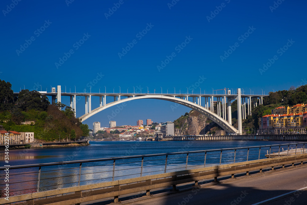 View of the Douro River and the Arrabida Bridge in a beautiful early spring day at Porto City in Portugal