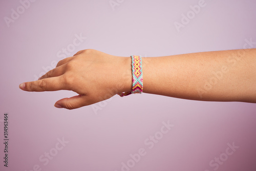 Model arm with beautiful handmade colorful bracelet on wrist