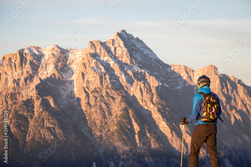 Lonely person portrait and Mountain Birnhorn Saalbach sunset view in the valley