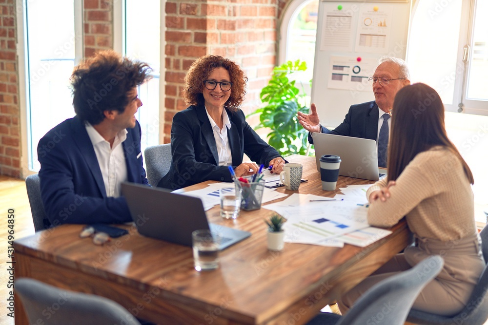 Group of business workers smiling happy and confident. Speaking with smile on face working together at the office. Group of business workers smiling happy and confident. Speaking with smile on face working together at the office.