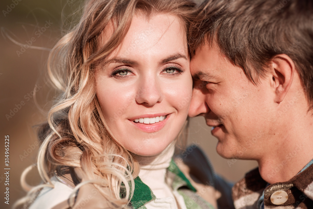 Portrait Of A Young Romantic Couple Smiling And Hugging Each Other In Nature Portrait Of A Young Romantic Couple Smiling And Hugging Each Other In Nature