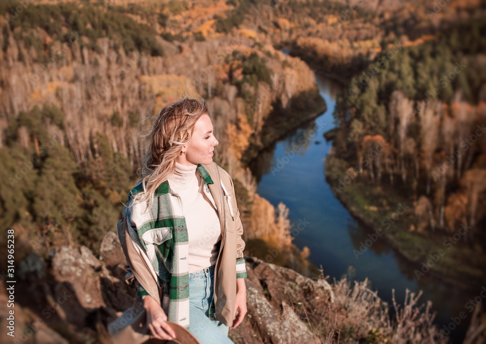 Naklejka premium Young Blonde Walking On top of a mountain in autumn