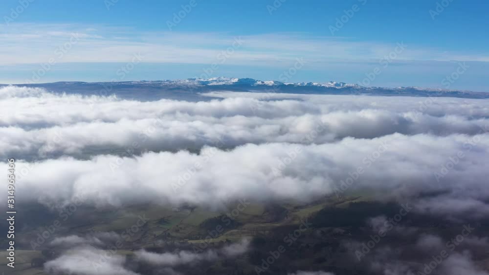 Above clouds aerial view snowy Puy de Sancy mountains volcano Massif Central France Auvergne Above clouds aerial view snowy Puy de Sancy mountains volcano Massif Central France Auvergne
