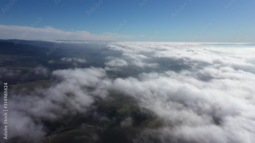 aerial view of mountains above clouds France Massif Central Auvergne sunny day blue sky aerial view of mountains above clouds France Massif Central Auvergne sunny day blue sky