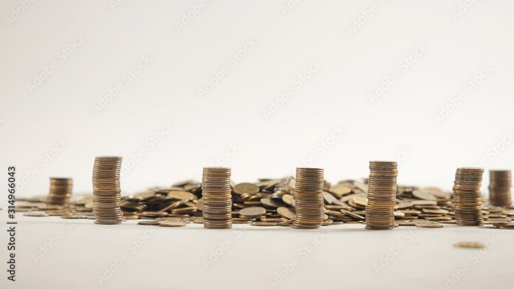 The concept of money. Columns of gold coins in the form of skyscrapers or Stonehenge. Close-up hands make up stacks of coins. Smoke. Garland. The concept of money. Columns of gold coins in the form of skyscrapers or Stonehenge. Close-up hands make up stacks of coins. Smoke. Garland.