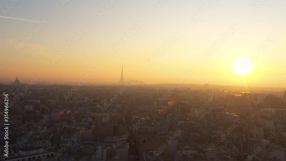 Sun setting over Paris Skyline Eiffel Tower rooftops France capital Sun setting over Paris Skyline Eiffel Tower rooftops France capital