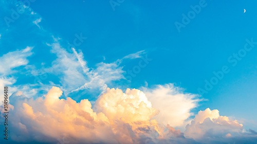 White clouds with blue sky on the sunset summer background © Vadim