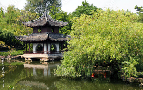Garden view in wealthy family in China, planting flowers and trees and gazebo with pond landscape