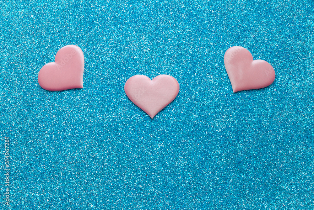 Obraz premium Valentines day pattern background flat lay pink hearts on a glittering classic blue background with copy space. love wedding romantic concept, minimal top view