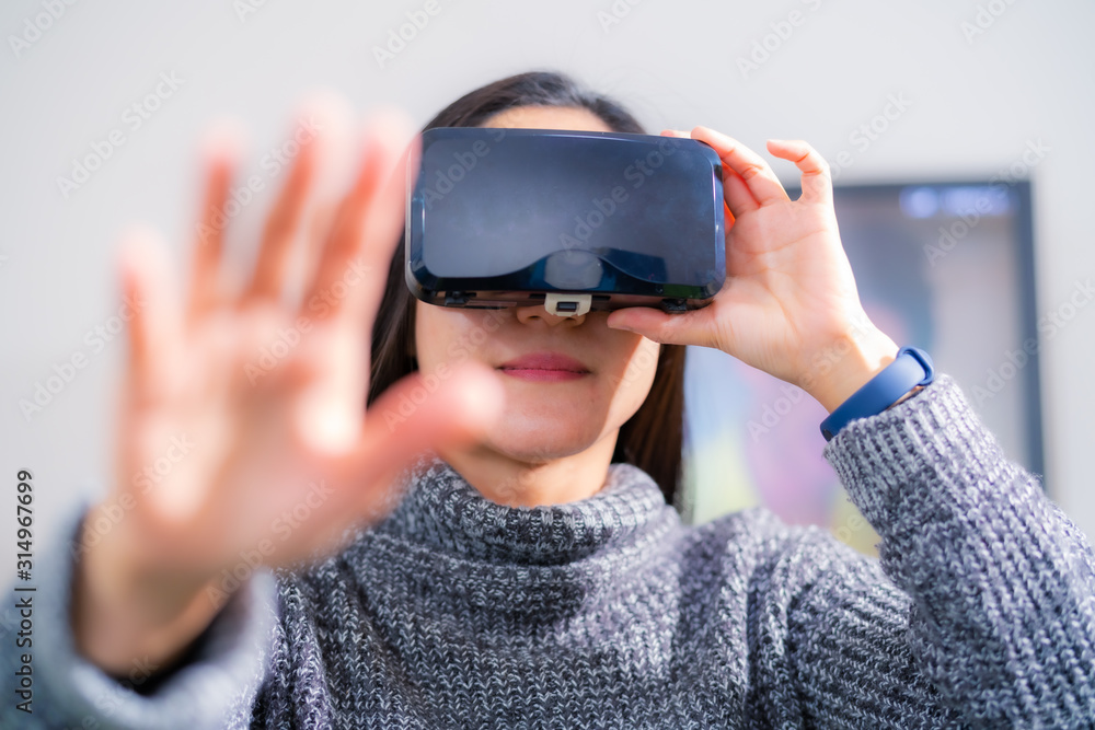 woman wearing virtual reality glasses. Smartphone using with VR headset woman wearing virtual reality glasses. Smartphone using with VR headset