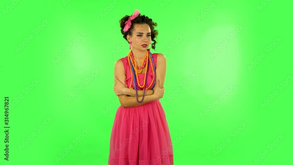 Beautiful sweet girl froze and trying to keep warm against green screen Beautiful sweet girl froze and trying to keep warm against green screen