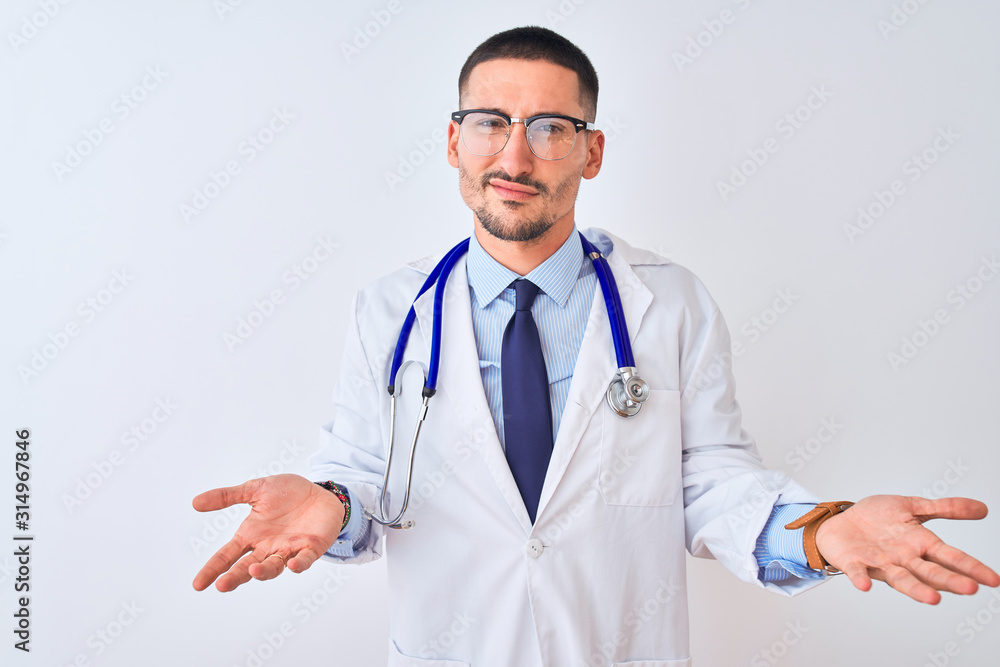 Young doctor man wearing stethoscope over isolated background clueless and confused with open arms, no idea concept.