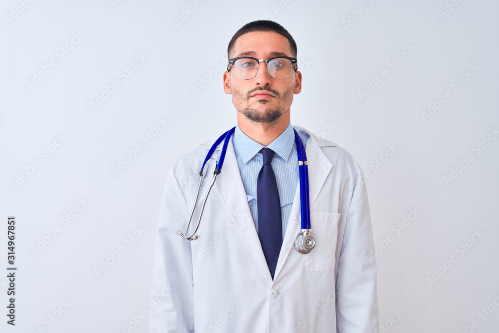 Young doctor man wearing stethoscope over isolated background Relaxed with serious expression on face. Simple and natural looking at the camera. Young doctor man wearing stethoscope over isolated background Relaxed with serious expression on face. Simple and natural looking at the camera.