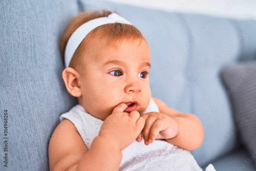 Adorable baby lying down on the sofa at home. Newborn relaxing and resting comfortable Adorable baby lying down on the sofa at home. Newborn relaxing and resting comfortable