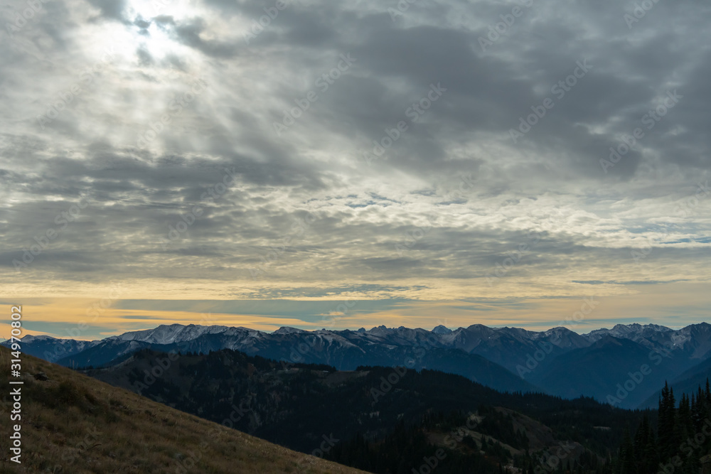 Sun Breaks Through Clouds Over Washington Mountains