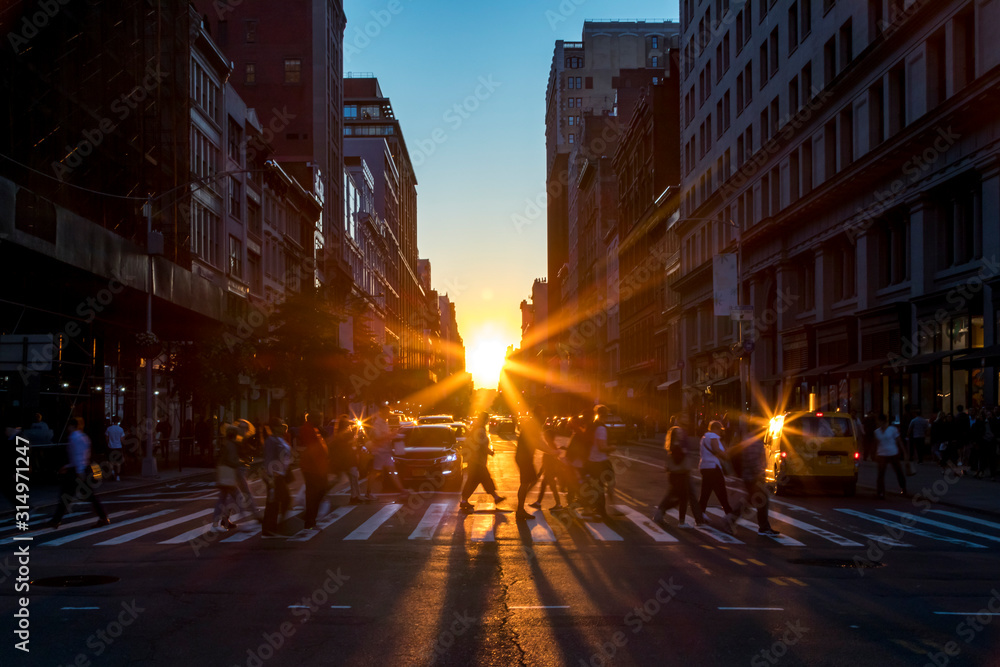 Crowds of diverse people walk across a busy intersection on 5th Avenue in New York City with sunlight background